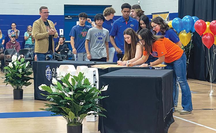 Photo submitted by Joe Theobold – Q.I. Roberts Junior-Senior High School Principal and Florida State University graduate Joe Theobold watches Tuesday as seniors commit to attending his alma mater’s rival, the University of Florida.