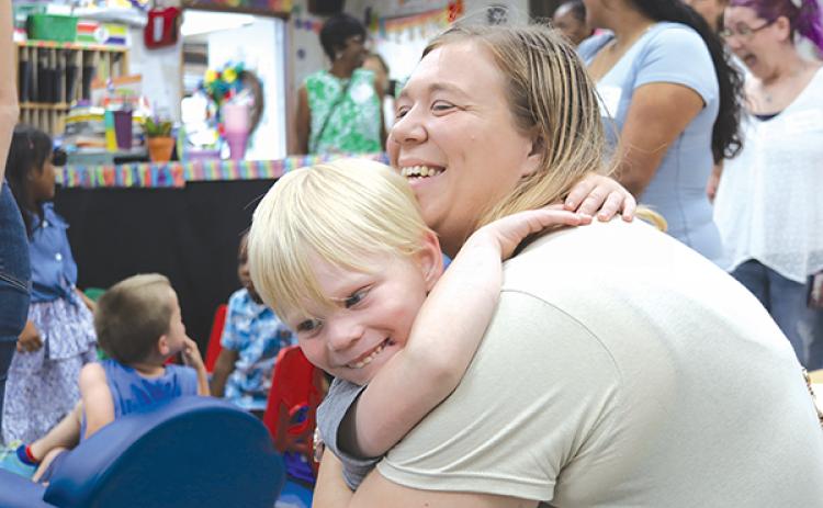 TRISHA MURPHY/Palatka Daily News – Aiden Pacetti, 4, gives his mom, Casey, a hug at the Mother’s Day tea in his prekindergarten class at the Mellon Learning Center on Friday.